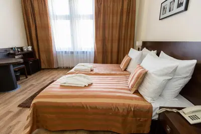a hotel room with two beds and a telephone at Spatz Aparthotel in Kraków