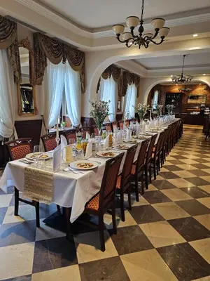 a long dining room with a long table at Hotel Polonia in Kraków