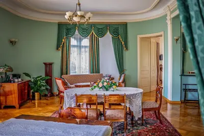 a living room with a table and chairs at Hotel Polonia in Kraków