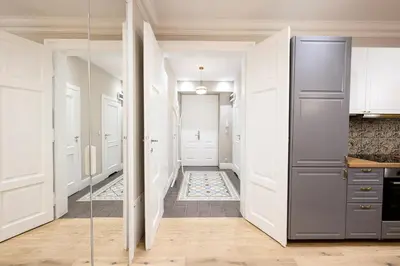 a hallway with a glass door leading to a kitchen at Native Apartments Nowowiejska 9 in Kraków