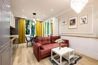 a living room with a couch and a table at Native Apartments Nowowiejska 9 in Kraków