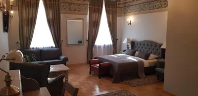 a living room with a bed and a couch at Hotel Mikołaj in Kraków