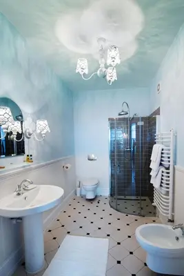 a bathroom with a sink and a shower and a toilet at Hotel Mikołaj in Kraków