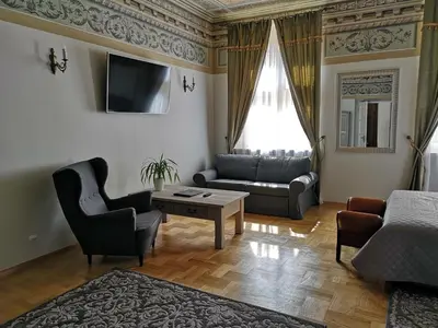 a living room with a couch and a table at Hotel Mikołaj in Kraków