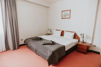 a bedroom with a large white bed in a room at Piwnica Rycerska Kęty in Kęty