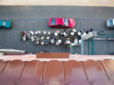 an overhead view of a parking lot with a red car at Antique Apartments Plac Szczepański in Kraków