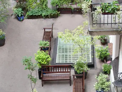 an overhead view of a patio with benches and plants at Antique Apartments Plac Szczepański in Kraków