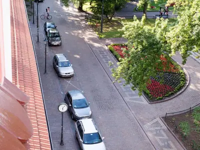 a group of cars parked on a city street at Antique Apartments Plac Szczepański in Kraków