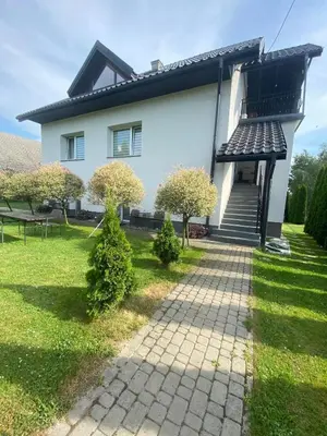 a house with a walkway in front of it at Pokoje Gościnne Kossowa Zator Energylandia in Kosowa