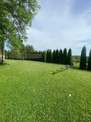 a field of green grass with a fence and trees at Pokoje Gościnne Kossowa Zator Energylandia in Kosowa