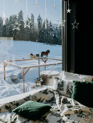a living room with a couch and a table at oto.domki in Rokiciny Podhalanskie