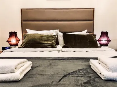 a bedroom with a large bed with two lamps at Charming Apartment, Wawel & Old Town Krakow II in Kraków