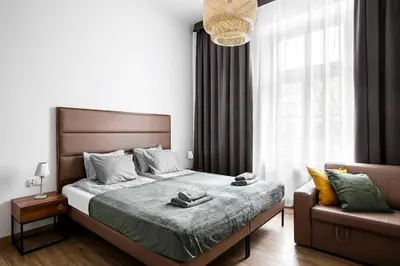 a bedroom with a large bed and a couch at Charming Apartment, Wawel & Old Town Krakow II in Kraków