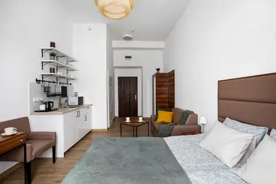a bedroom with a bed and a living room at Charming Apartment, Wawel & Old Town Krakow II in Kraków