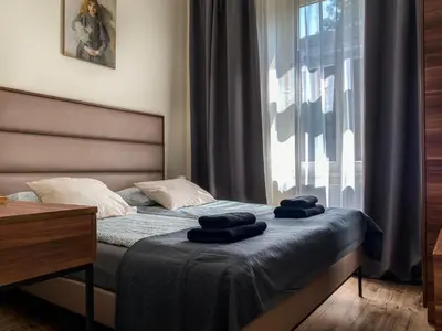 a bedroom with a bed with two towels on it at Charming Apartment, Wawel & Old Town Krakow II in Kraków