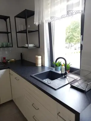 a kitchen counter with a sink and a window at Apartament przy Obozie in Oświęcim