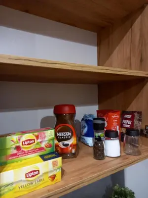 a shelf with some food items on it at Apartament przy Obozie in Oświęcim