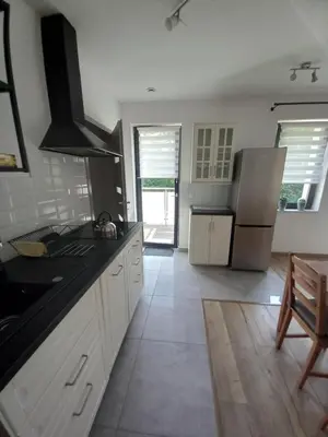 a kitchen with a refrigerator and a counter top at Apartament przy Obozie in Oświęcim