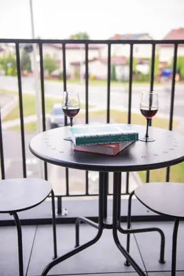 two glasses of wine and a book on a table at Forest 21 by Housine in Zator