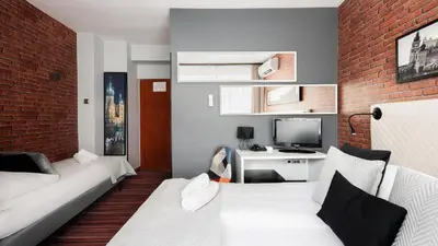 a living room with a couch and a television at Hotel Delta in Kraków