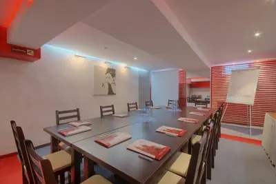 a large dining room with a long table and chairs at Hotel Delta in Kraków