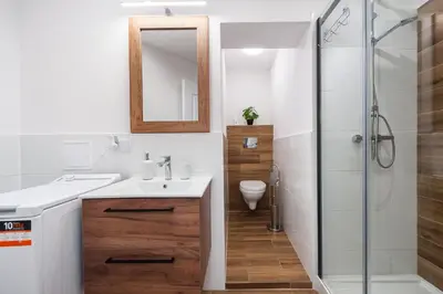 a bathroom with a sink and a shower at Szpitalna Premium Apartment in Kraków