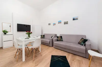 a living room with a couch and a table at Szpitalna Premium Apartment in Kraków