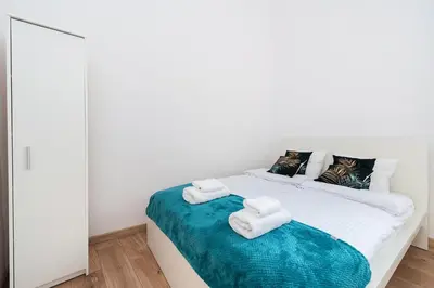 a bedroom with a bed with towels on it at Szpitalna Premium Apartment in Kraków