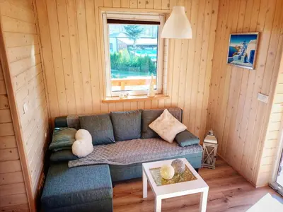 a bedroom with a bed in a wooden cabin at Alma in Rzyki