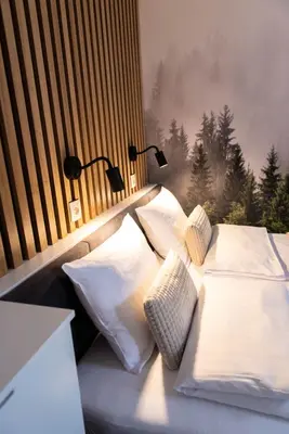 two beds in a room with two lamps on the wall at Forest 47 by Housine in Zator