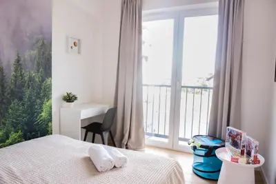 a bedroom with a bed and a large window at Forest 47 by Housine in Zator