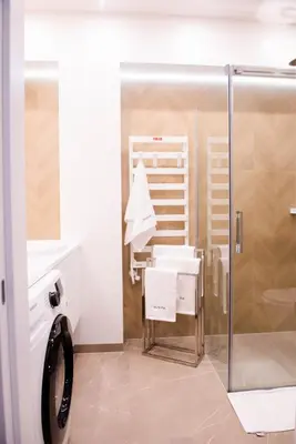 a bathroom with a shower and a sink and a mirror at Forest 47 by Housine in Zator