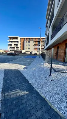 an empty parking lot next to a building at Forest 47 by Housine in Zator