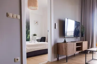 a bedroom with a bed and a television on a cabinet at Forest 47 by Housine in Zator
