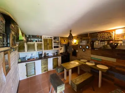 a kitchen with a table and chairs in a room at Zielone Okiennice in Bachowice
