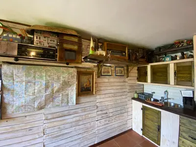 a kitchen with wooden walls and a map on the wall at Zielone Okiennice in Bachowice