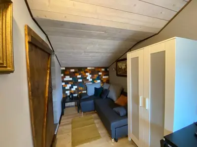a living room with a blue couch in a room at Zielone Okiennice in Bachowice