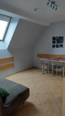 a living room with a table and chairs and a couch at Apartamenty Suzyw Pilsko in Pewelka