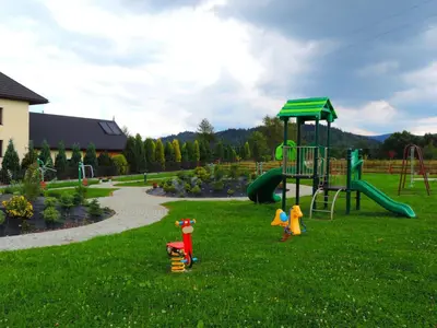 a park with a playground with a slide at Apartamenty Suzyw Pilsko in Pewelka