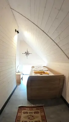 a large bed in a room with an attic at Level780 in Koszarawa