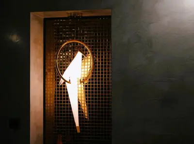 a light up tennis racket on a wall at Apartament z Jacuzzi w Sercu Krakowa in Kraków