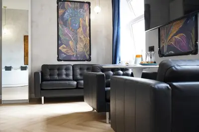 a living room with a couch and a table at Apartament z Jacuzzi w Sercu Krakowa in Kraków