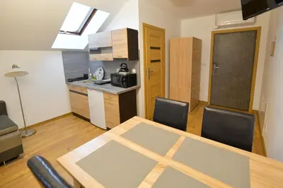 a kitchen with a large clock on the wall at Apartamenty Tilia Laskowa - Zator in Laskowa
