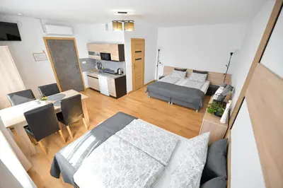 a kitchen and dining room with a table and chairs at Apartamenty Tilia Laskowa - Zator in Laskowa