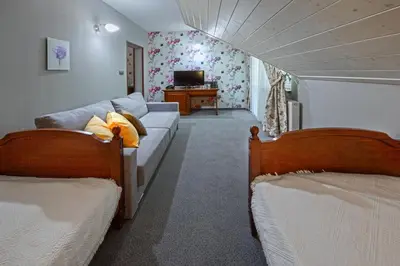 a living room with two beds and a couch at Hotel Zalesie in Bochnia