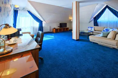 a living room with a couch and a table at Hotel Zalesie in Bochnia