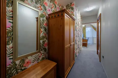 a hallway with a mirror and a wooden cabinet at Hotel Zalesie in Bochnia