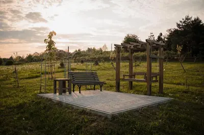 a park bench and a swing on a field at Domki na Górniej Łące - Domek Słowik in Łazany