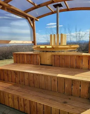 a wooden deck with a pergola with a view at Domki na Górniej Łące - Domek Słowik in Łazany
