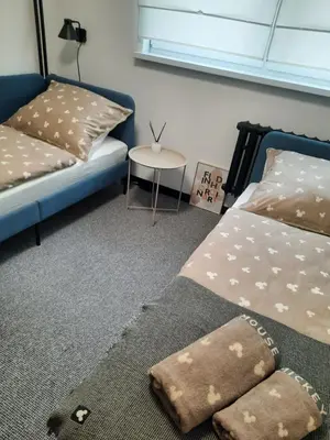 a bedroom with two beds and a small table at GOLD&BLACK OŚWIĘCIM CENTRUM in Oświęcim